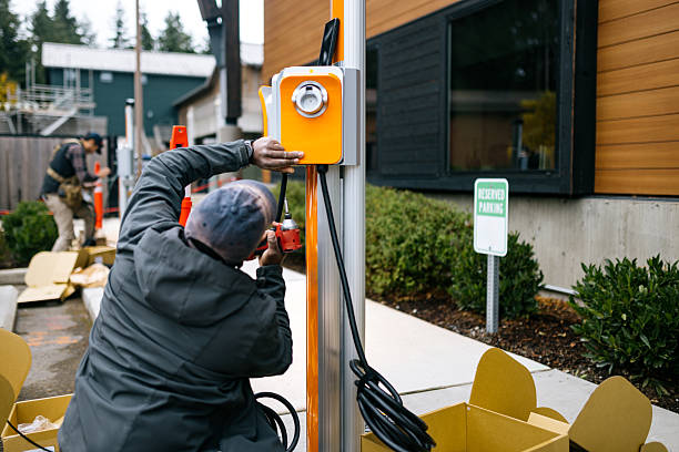 Homeowner charging electric vehicle beside newly installed garage wall charger
