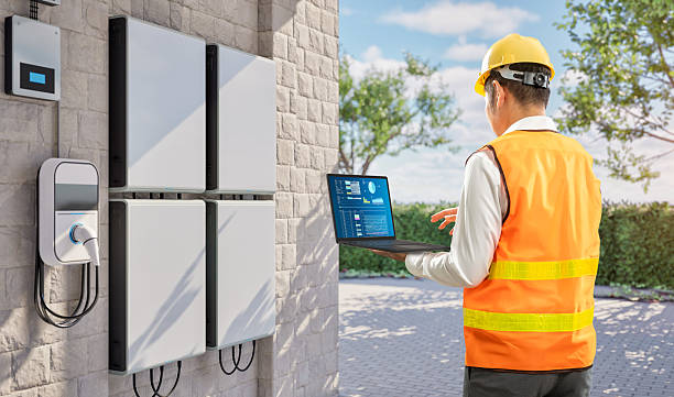 Electrician checking EV charger wiring and load capacity at residential panel