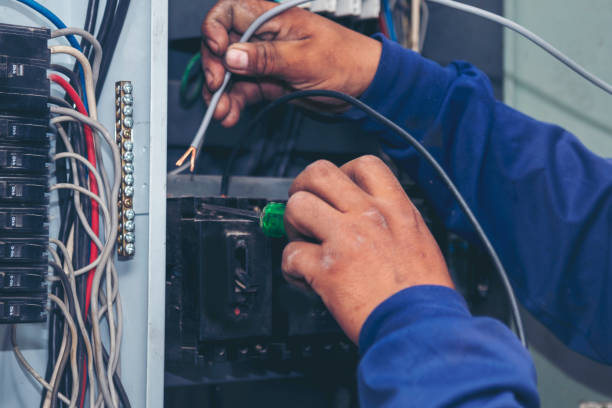 electrical-panel-repair-7 Electrician repairing residential breaker panel after repeated tripping in older home