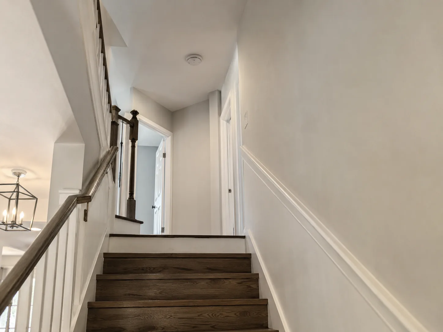 Technician checking Smoke Detectors in a Freehold - NJ hallway during a careful home safety inspection